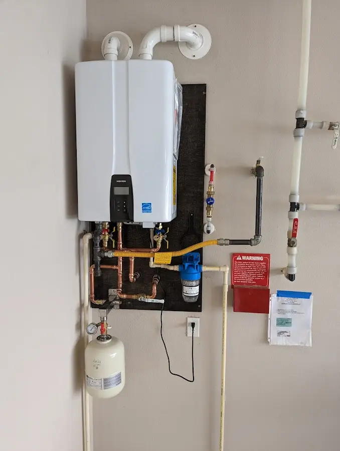 Professional plumber installing copper piping in a Ambler home